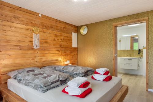 two beds in a room with a wooden wall at Ferienwohnung im Grünen in Oberried