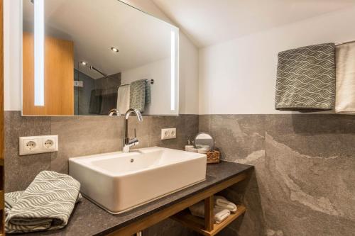 a bathroom with a white sink and a mirror at Ferienwohnung Riepl in Schliersee