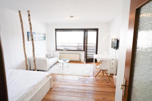 a bedroom with a bed and a living room at Zentral und Naturnah in Penzberg