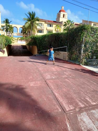 a young child walking down a road at Beautiful condo a few steps to sea in Cancún