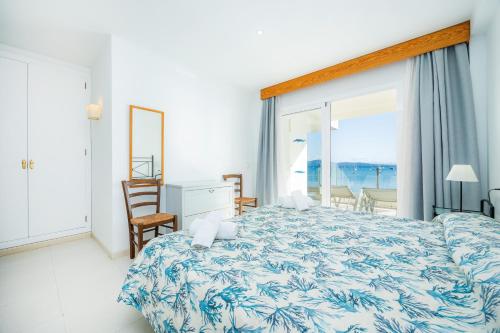 a bedroom with a large bed with a view of the ocean at Catalina 3b in Port de Pollensa