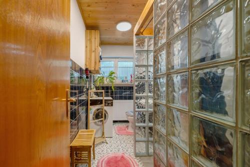 a laundry room with a wall of glass doors at Ferienhaus Störzel - Wohnung A in Hundheim