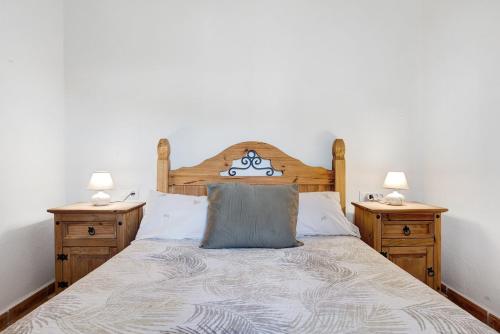 a bedroom with a bed with two night stands at Los Olivos in Barbate
