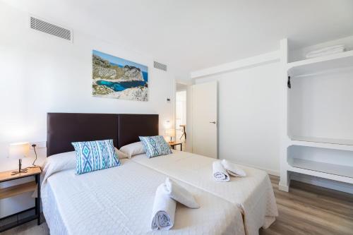 a bedroom with a large bed with towels on it at Albercutx Pollentia 3 in Pollença