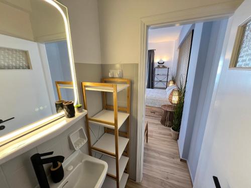 a bathroom with a sink and a mirror and a bed at aeolian blu 1 in Parikia