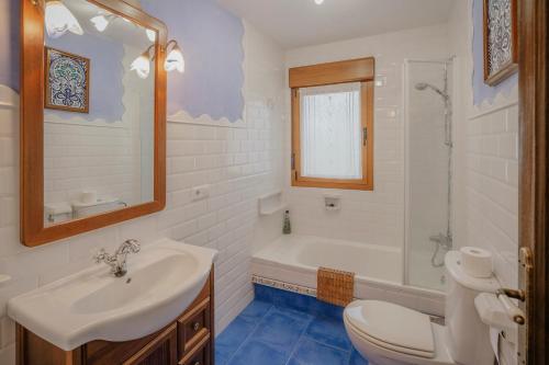 a bathroom with a sink and a tub and a toilet at La Cardeñuela in Burgos