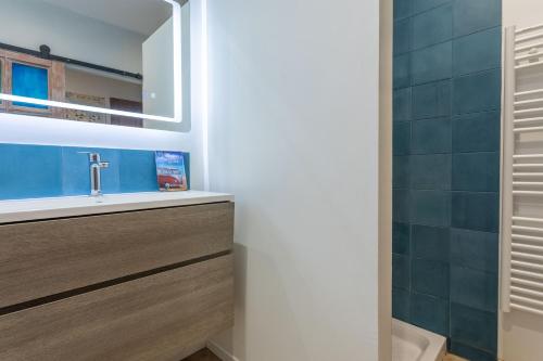 a bathroom with a sink and a mirror at Maison de charme avec jacuzzi in Lorgues