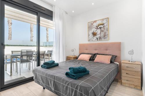 a bedroom with a bed with two green pillows on it at Belle in Orihuela Costa