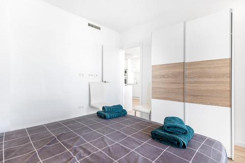 a room with two green towels on a tile floor at Belle in Orihuela Costa