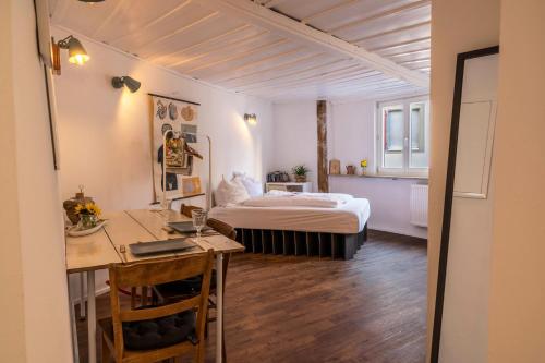 a bedroom with a bed and a desk in a room at Fewo Sankt Johann ll in Konstanz