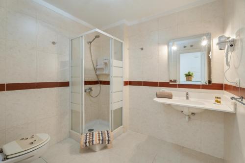 a bathroom with a shower and a toilet and a sink at Chasna Sunset in Adeje