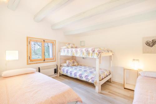 a bedroom with two beds and a bunk bed at Can Favo in Copóns