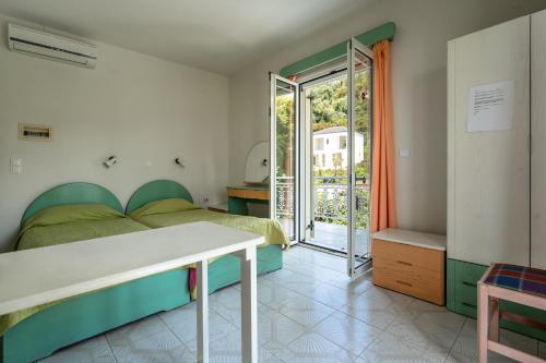 a bedroom with a bed and a sliding glass door at Angela partial sea view 6 in Kefallonia
