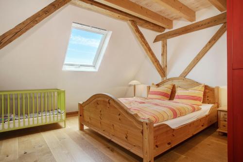 a bedroom with a wooden bed and a window at Hof Sinnenberg in Deggenhausertal