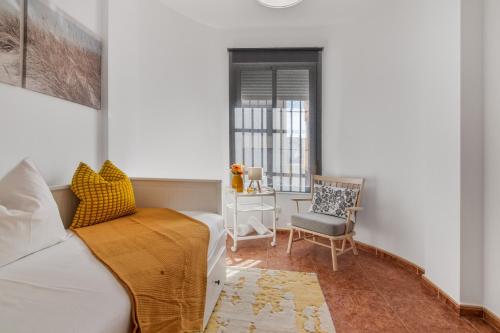 a living room with a couch and a chair at Villa Marília in Ayamonte