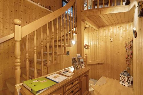 a wooden cabin with a staircase in a room at Ferienhaus Schmalzgrube in Jöhstadt