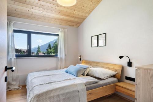 a bedroom with a large bed with a window at Stackler54 - mit Balkon in Neustift im Stubaital