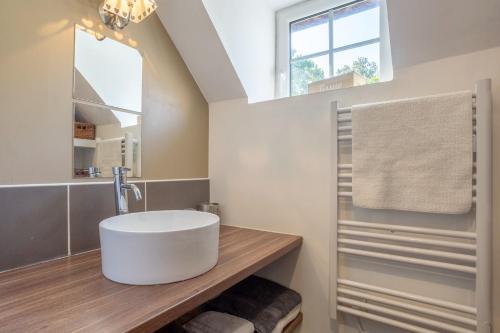 a bathroom with a tub sink and a window at La bonne descente in Fouesnant