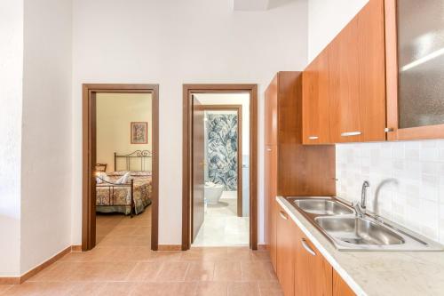 a kitchen with a sink and a bathroom at Le Colonie - Pescoluse in Presicce