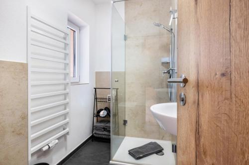 a bathroom with a glass shower and a sink at Fewo Am Steinbach - Stoaboch in Reit im Winkl