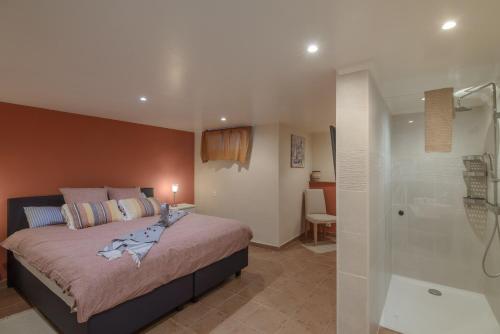 a bedroom with a bed and a walk in shower at Villa Lara in Benalup Casas Viejas