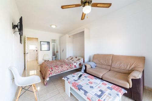 a living room with a couch and a bed at Gaviotas 4 in Aguadulce