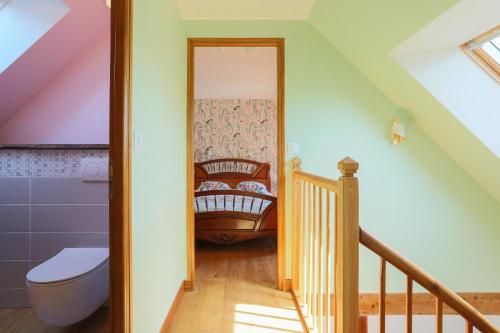 a attic bathroom with a toilet and a staircase at Le paradis sur mer in Paimpol