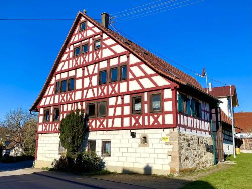 a large red and white building with at Ferienwohnungen Im Eugenhaus in Rosenfeld