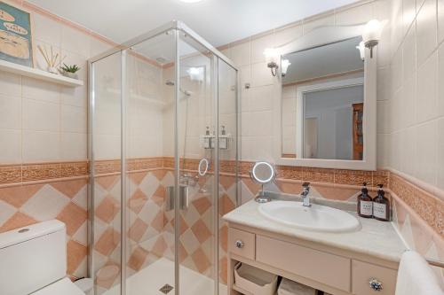 a bathroom with a sink and a shower at Casa Eusebia in Arona