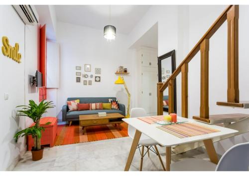 a living room with a table and a couch at Duplex Seville-Historic Center in Seville