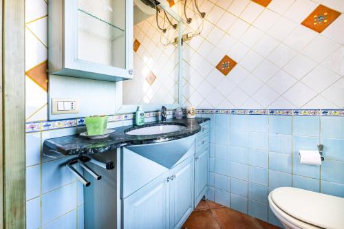 a bathroom with a sink and a toilet at I girasoli in Villasimius