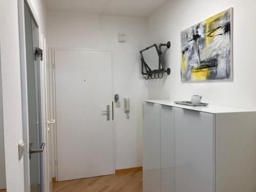 a white kitchen with a white counter and a door at Dmon-Home in Tettnang