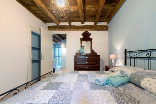 a bedroom with a bed with a dresser and a mirror at Prima Del Cielo - Appartamento Lago in Esino Lario