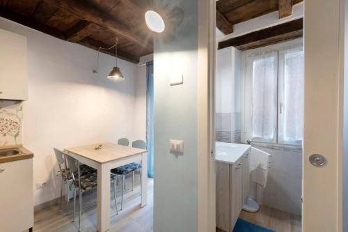 a kitchen and dining room with a table and a sink at Prima Del Cielo - Appartamento Lago in Esino Lario