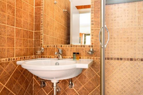 a bathroom with a sink and a shower at Alkionides Apartment 3 in Agios Nikitas