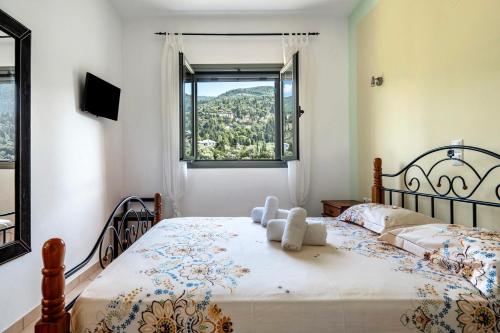 a bedroom with a bed with a teddy bear on it at Alkionides Apartment 3 in Agios Nikitas