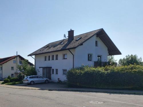 a white house with a car parked in front of it at Haus Hanni in Höchenschwand