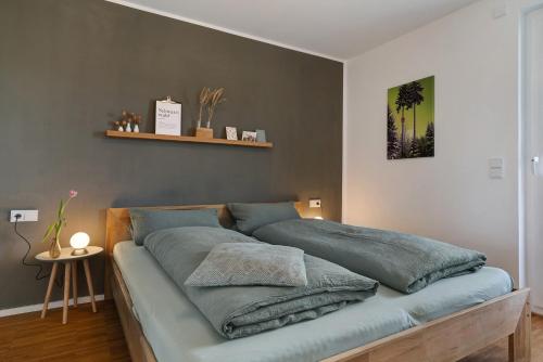 a bed with pillows on it in a bedroom at Kölsch-Marie in Durbach