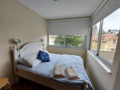 a bedroom with a bed with two towels on it at Estoril Sea You in Estoril