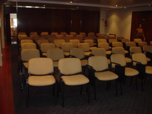 a room with a bunch of chairs and a podium at Hotel Santa Maria in Alcobaça