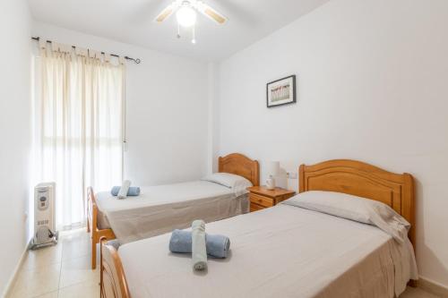 a bedroom with two beds and a window at Edificio Menorca in Balcon del Mar