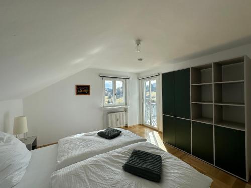 a bedroom with a large white bed and a window at Auerer Retreat in Frauenau