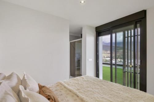a bedroom with a bed and a large window at Suitme-Agaete in Agaete