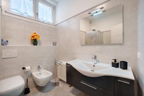 a bathroom with a sink and a toilet and a mirror at Ragamà Massino Visconti in Massino Visconti
