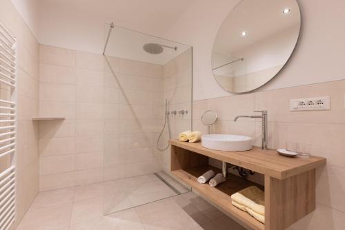 a bathroom with a sink and a mirror at Kleon 3 in Rifiano
