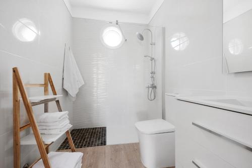 a white bathroom with a shower and a toilet at Casa Alsa Beach in Icod de los Vinos