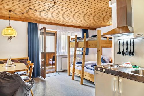 a kitchen and a living room with a bunk bed at Studio Hochzillertal mit Sauna in Ried im Zillertal