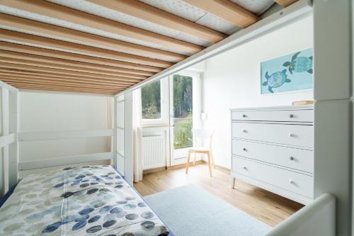 a bedroom with a bed and a wooden ceiling at Sonnenterrasse 9 in Fischerbach