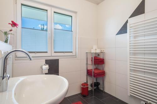 a bathroom with a white tub and a window at Ferienhof Weber Ferienwohnung Buche in Neukirch