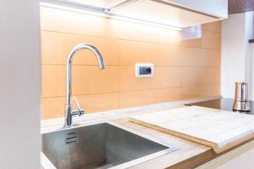 a kitchen with a sink and a counter top at Casa Muffolina in Canazei